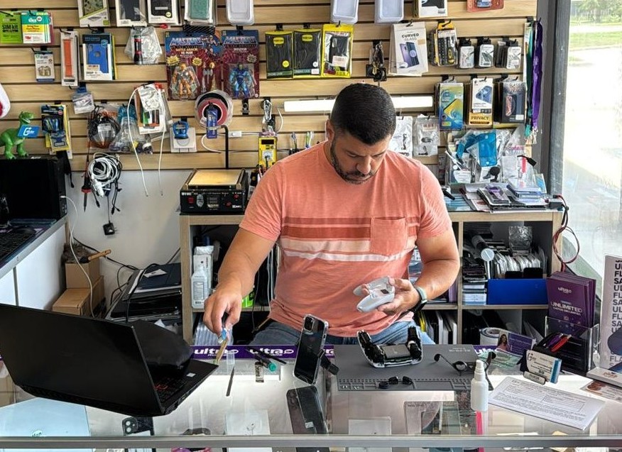 Cellular Plus Services technician repairing a laptop motherboard in Katy, TX